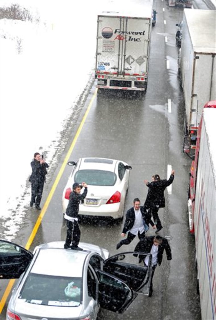 A group of young Jewish men traveling in a car with Michigan plates pass the time dancing to music that blared from their car while they are stuck in a traffic jam on Monday, Dec. 6, 2010, on Interstate 80, about 3 miles east of West Middlesex, Pa. Miles of east traffic was stopped for hours in Mercer County during the afternoon because of a series of weather-related accidents. (AP Photo/The Herald, Sharon, Pa., David E. Dale)
